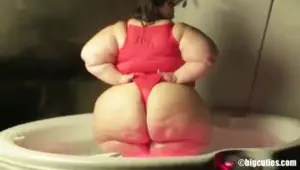 Fat ass swallows that bathing suit