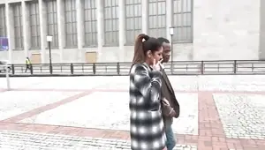 Alluring brunette sucks a long black pole