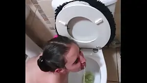 Pigtailed teen sucks dick after being pissed on and licking the toilet clean face spitting and slapping